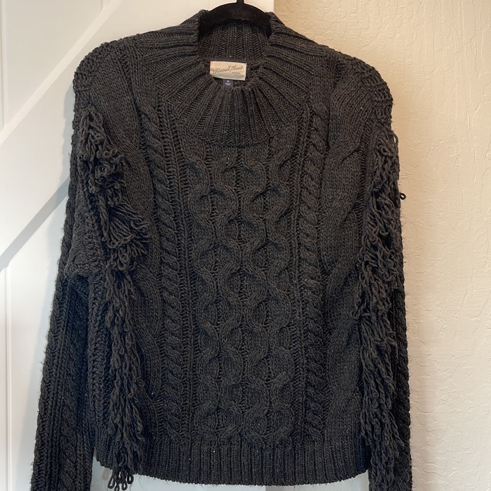 Fringey cable knit sweater